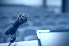 Microphone on table in front of empty seats