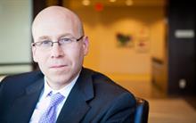 Michael Goldberg - Tax Lawyer Image: Michael Goldberg sitting in chair looking at camera